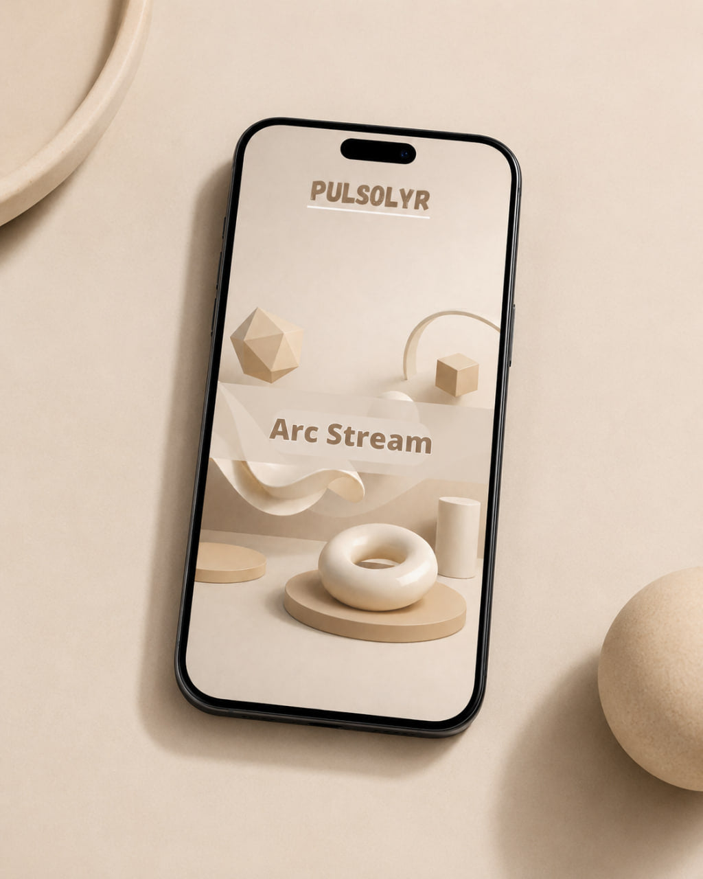A smartphone lying on a warm beige surface, displaying a minimalist 3D-rendered design mockup with the text 'PULSOLYR' and 'Arc Stream.' The phone has a black border and is photographed in a clean, styled flat-lay setting with soft neutral props.